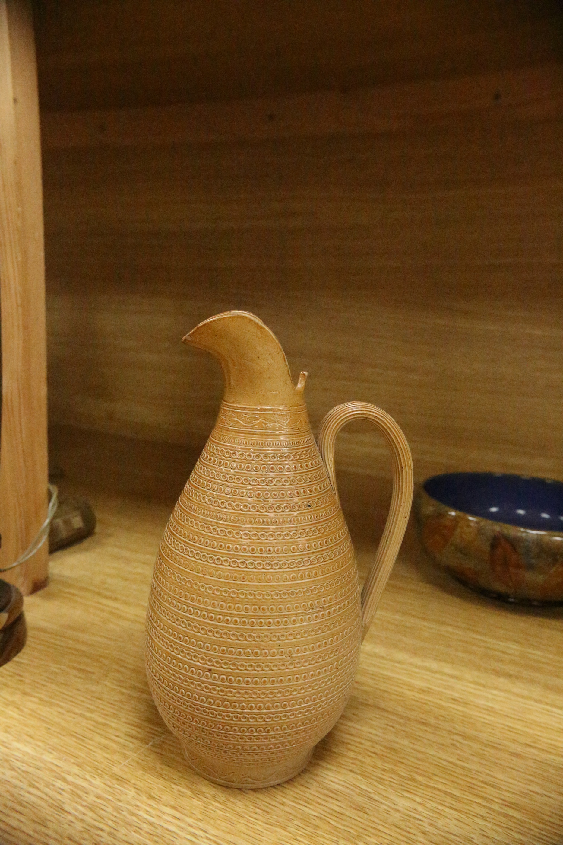 Three Royal Doulton jugs, two vases and two natural foliage ware dishes, tallest vase 23cm high. Condition - smallest jug cracked near rim, two handled vase glazing blemish near base